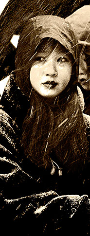 woman looking over her shoulder in the snow at chinese new year parade chinatown boston ma