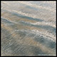 encaustic painting of soft ocean water pulling over sand